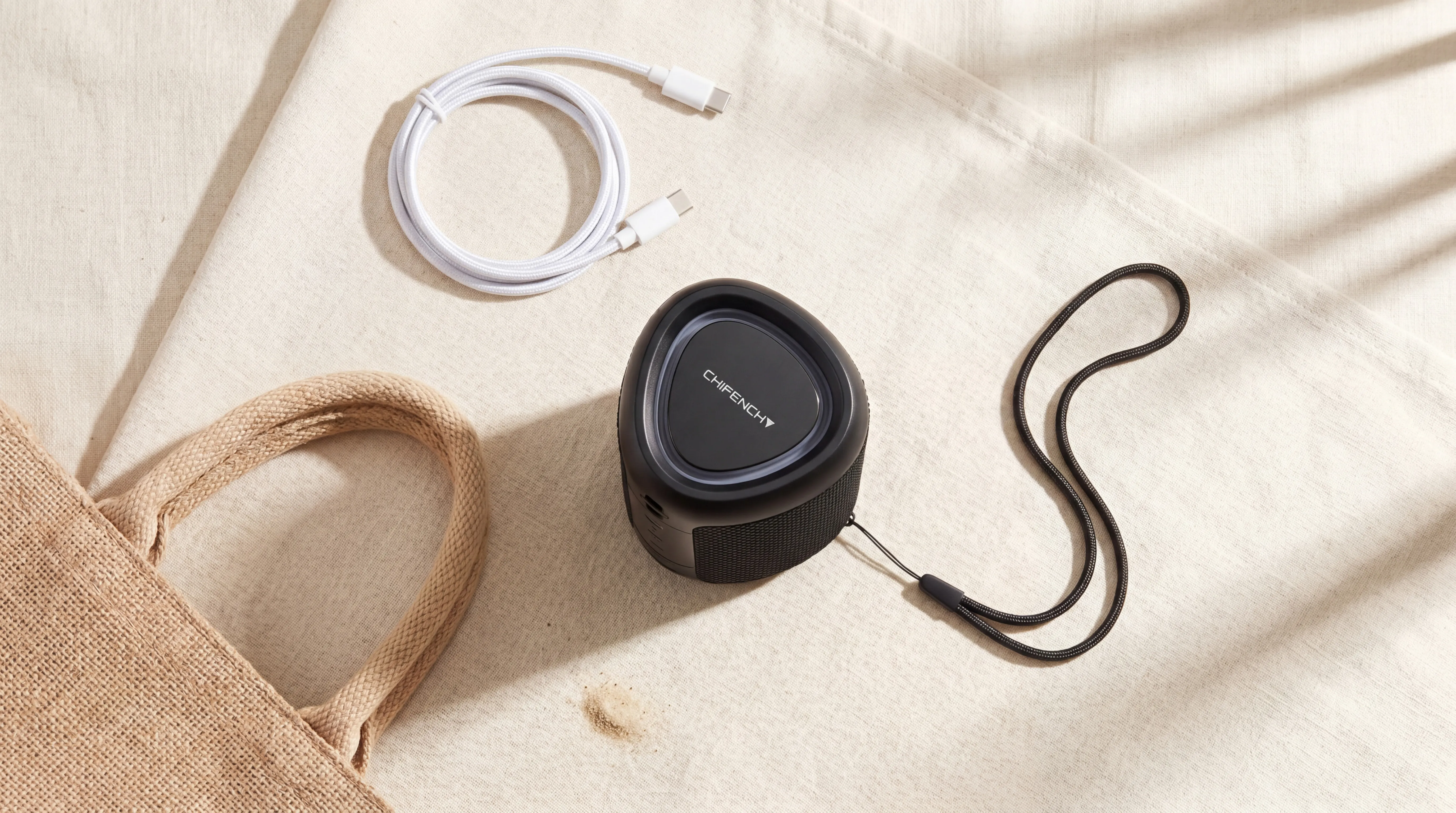 CHIFENCHY Bluetooth speaker first impression — compact size, matte rubber finish, braided wrist strap